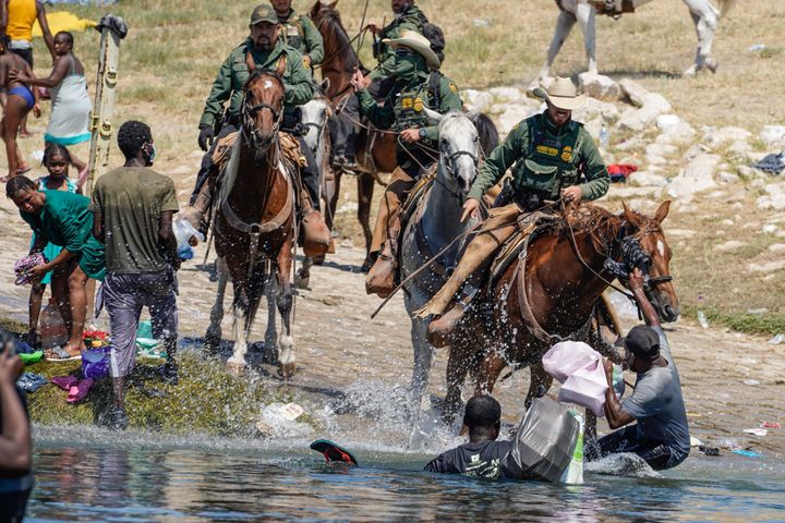 U.S. Border Patrol agents on horseback confront Haitian migrants trying to enter an encampment on the banks of the Rio Grande, in Del Rio, Texas, Sept. 19.