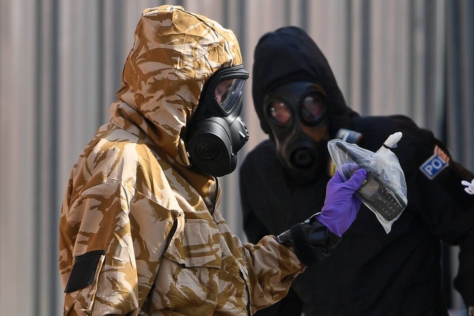 Investigators in protective suits looking into the poisoning in