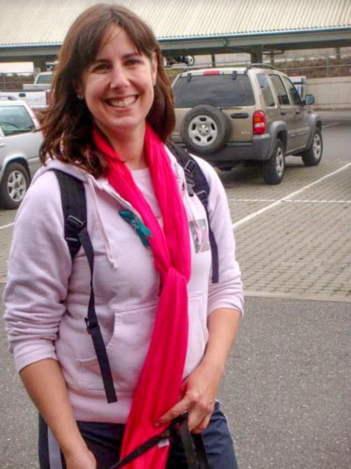 The author learned the symptoms of ovarian cancer a decade before her own diagnosis. In this 2010 photo taken at a Cancer Walk, she's wearing pink for breast cancer awareness and a small teal ribbon signifying ovarian cancer.