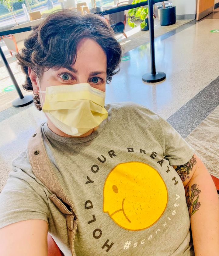 Almost a year after completing chemotherapy, the author waits in the hospital lobby, masked and by herself, as she did for most of her cancer treatment.