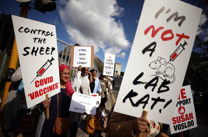 Anti-vaccine protestors hold placards a day after the country opened COVID-19 vaccinations for everyone 18 years old and above, outside Groote Schuur hospital in Cape Town, South Africa, on Aug. 21, 2021.