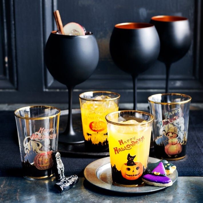 A set of four matte black and copper glasses