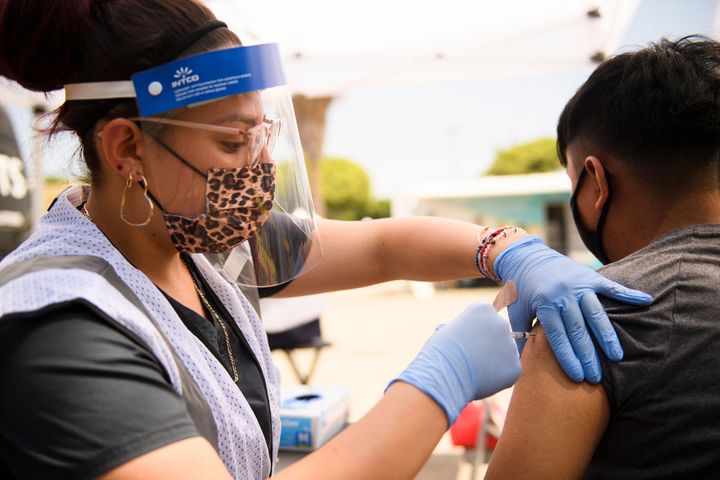 A 17-year-old receives a first dose of the Pfizer COVID-19 vaccine at a clinic in Los Angeles. Regular vaccinations have been down for children in the U.S. since the start of the pandemic, raising concerns of a resurgence of vaccine-preventable diseases and infections.