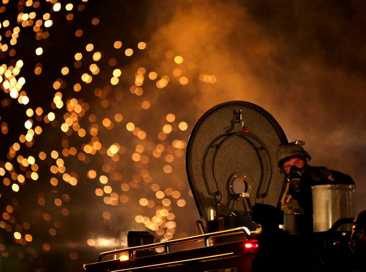 In this Aug. 17, 2014, file photo, a law enforcement officer watches from an armored vehicle during a protest for Michael Brown in Ferguson, Missouri.