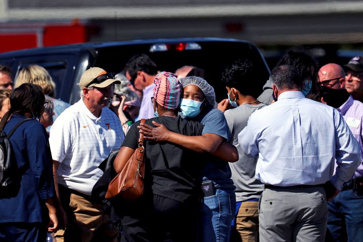 People embrace following a shooting at a Kroger grocery store in Collierville, Tennessee, on Thursday.