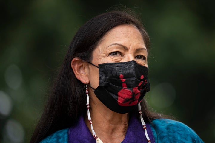 WASHINGTON, DC - JULY 29: Secretary of the Interior Deb Haaland prepares to take the stage during a welcome ceremony for a totem pole carved by the House of Tears Carvers of the Lummi Nation, on the National Mall July 29, 2021 in Washington, DC. The 25-foot totem pole was cut and hand-carved from a 400-year old Western red cedar tree. The House of Tears Carvers of the Lummi Nation transported the totem pole from Washington state to Washington, DC. (Photo by Drew Angerer/Getty Images)