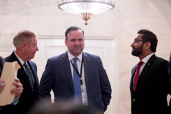 From left, Sen. Lindsey Graham (R-S.C.), White House social media director Dan Scavino, and National Security Council Senior Director of Counterterrorism Kash Patel outside the Diplomatic Room as then-President Donald Trump speaks at the White House on Oct. 27, 2019.