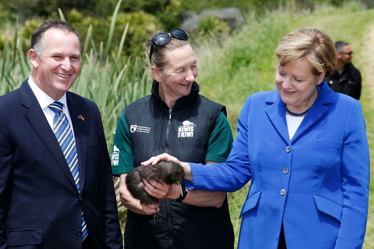  Merkel pets a native Kiwi named Whau in 2014