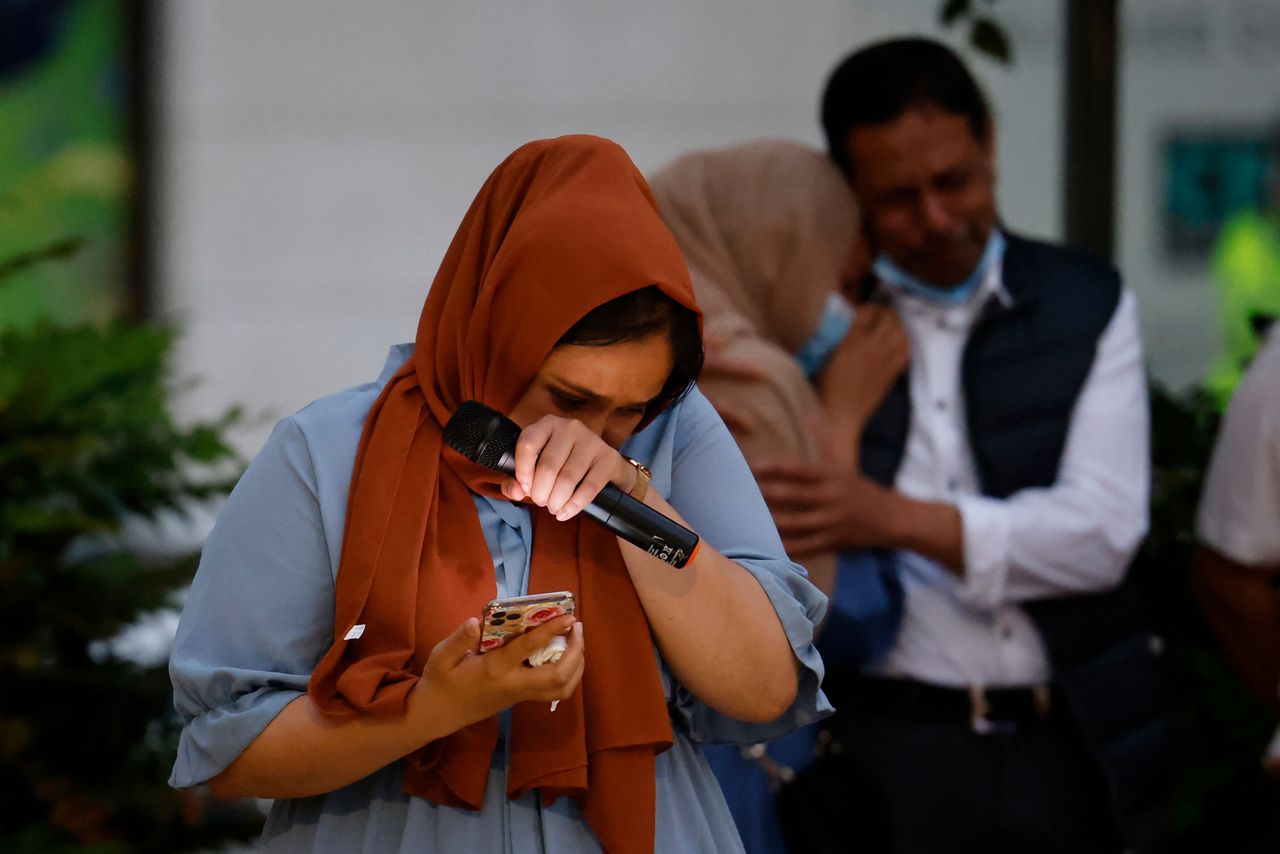 Jebina Yasmin Islam reacts as she pays tribute to her sister during the vigil.