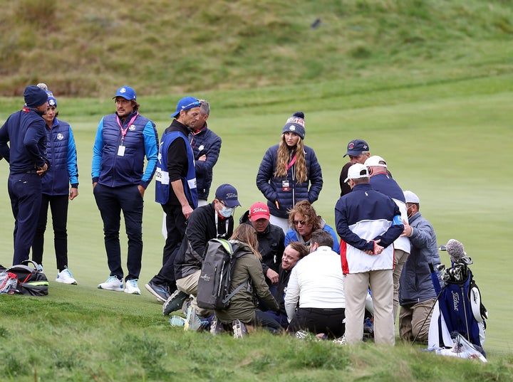 People surround Tom Felton after he collapsed during the golf games of celebrities before the 43rd Ryder Cup on the Whistling Straits course in Wisconsin.