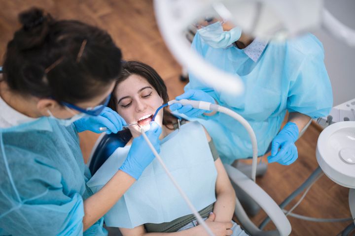 Shot of a young woman being examined at dental clinic