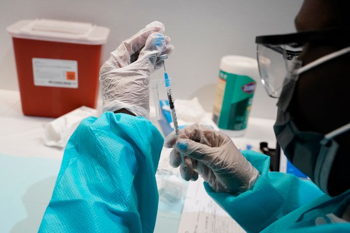 In this July 22, 2021, file photo, health care worker fills a syringe with the Pfizer COVID-19 vaccine at the American Museum of Natural History in New York. 