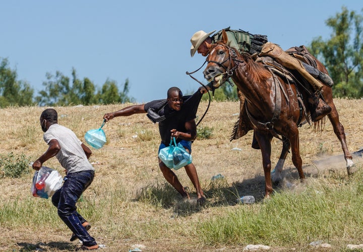 A Border Patrol agent on horseback tries to stop a Haitian migrant from entering an encampment in Del Rio, Texas, on Sept. 19.