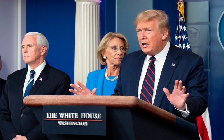 Then-Education Secretary Betsy DeVos stands with President Donald Trump and Vice President Mike Pence during a coronavirus update in March 2020.