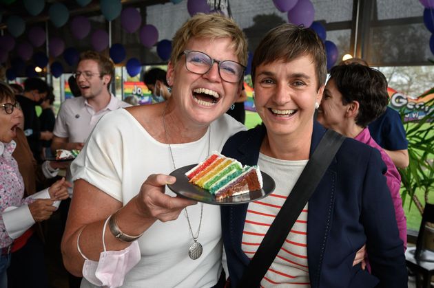 スイスの首都ベルンで開かれたイベントで、ウエディングケーキのスライスを手にするカップル（2021年9月26日）
