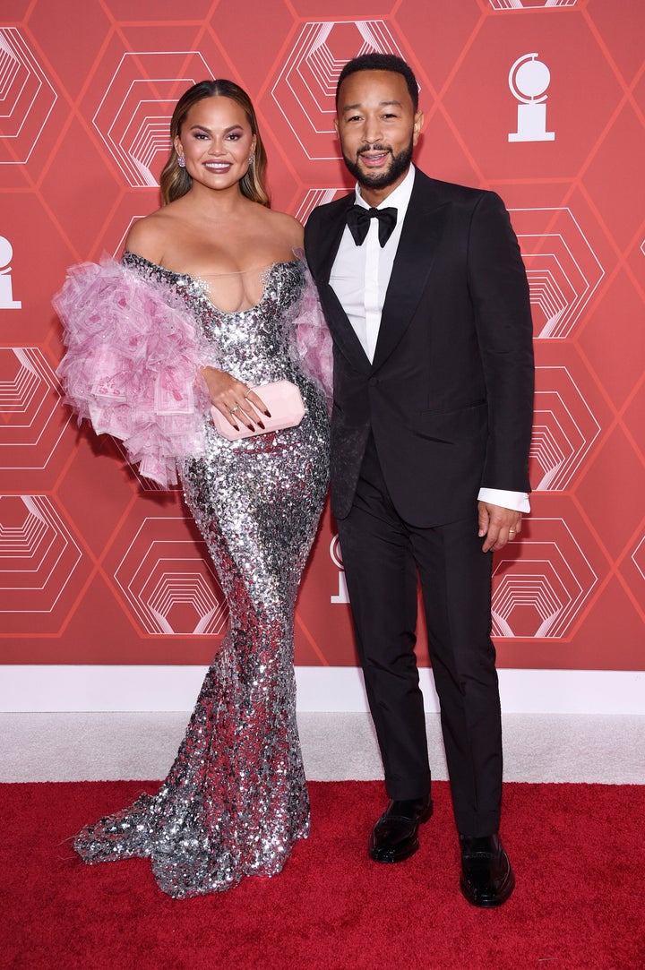 Chrissy Teigen, left, and John Legend arrive at the 74th annual Tony Awards at Winter Garden Theatre on Sunday, Sept. 26, 2021, in New York. (Photo by Evan Agostini/Invision/AP)