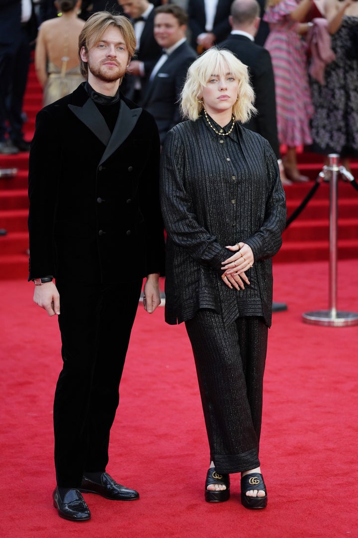 Finneas O'Connell and Billie Eilish walk the red carpet. 