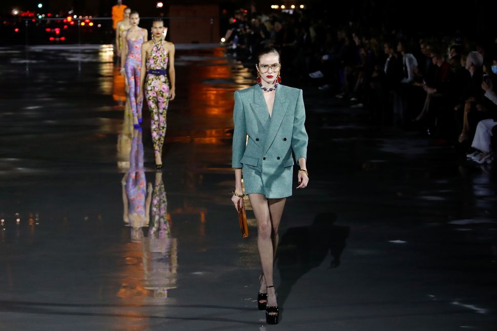 Μοντέλο παρουσιάζει μια δημιουργία του σχεδιαστή Anthony Vaccarello στο πλαίσιο της γυναικείας επίδειξης συλλογής για την άνοιξη/καλοκαίρι 2022 για τον οίκο μόδας Saint Laurent, μπροστά από τον Πύργο του Άιφελ κατά τη διάρκεια της εβδομάδας μόδας