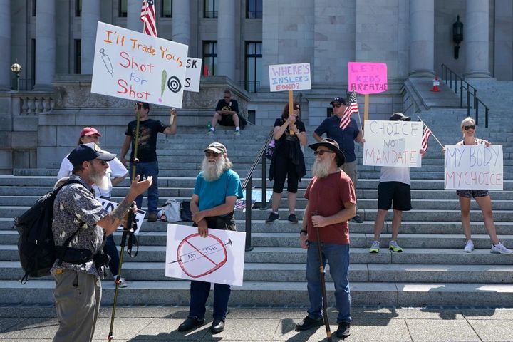 Protesters who oppose facemask and COVID-19 vaccine mandates gather outside the state Capitol building in Olympia, Washington, on Aug. 18.