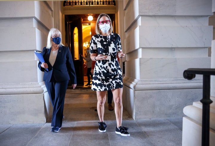 Sen. Kyrsten Sinema (D-Ariz.) and Sen. Patty Murray (D-Wash.) leave the U.S. Capitol on Wednesday as Congress juggles several high-stakes bills.