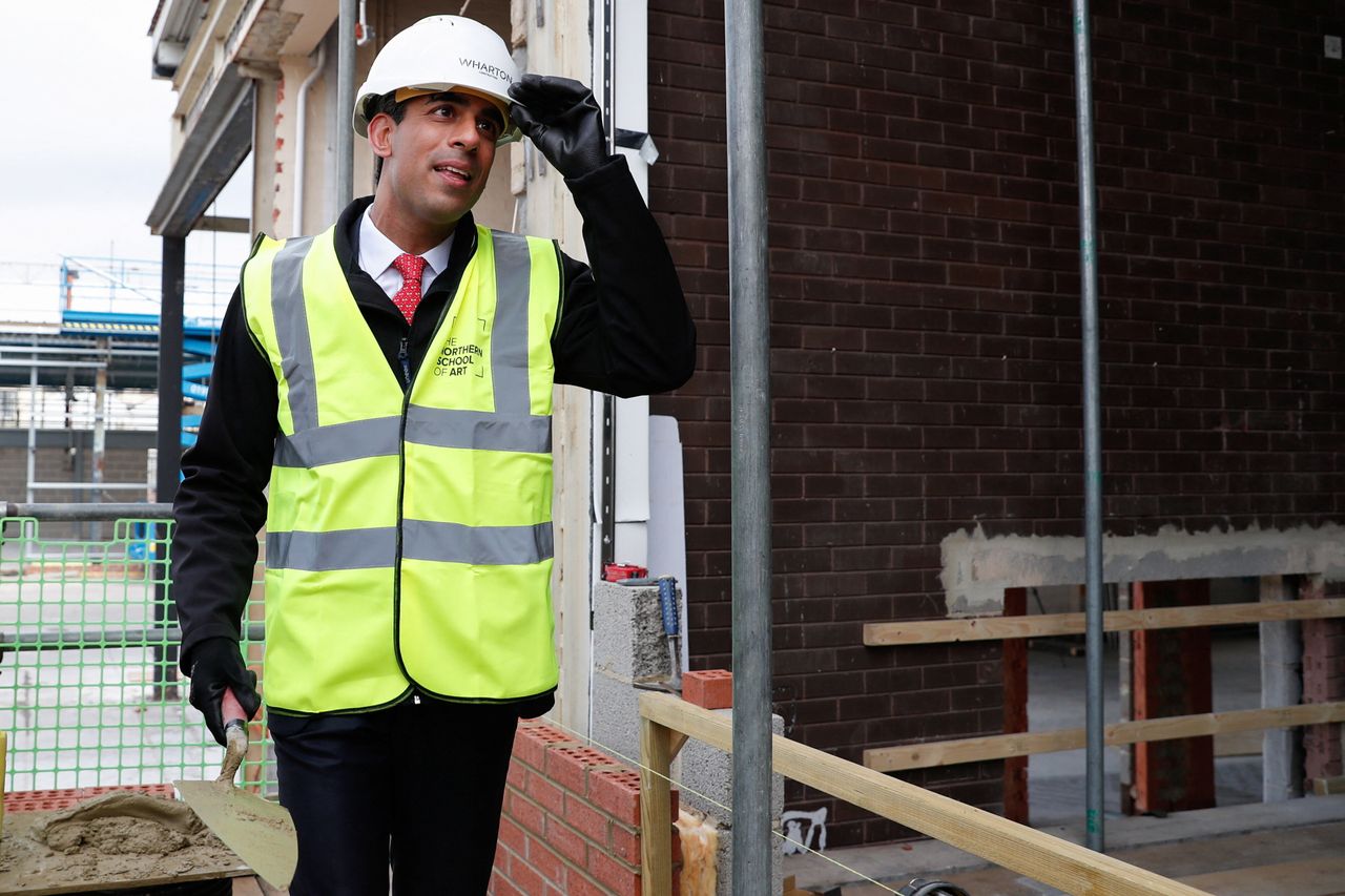 Chancellor Rishi Sunak wearing a hard hat and hi-vis on a construction site