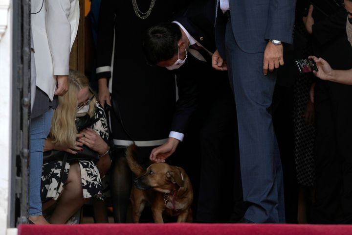 Slovakia's Prime Minister Eduard Heger pats Peanut the dog of his Greek counterpart Kyriakos Mitsotakis as they leave Maximos Mansion in Athens, Thursday, Sept. 30, 2021 (AP Photo/Thanassis Stavrakis)