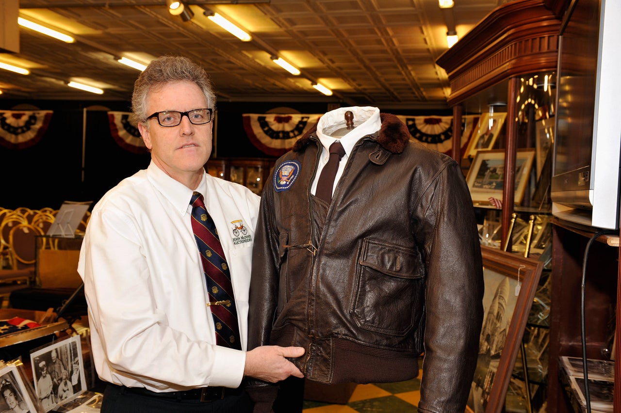 Daniel Meader holds JFK's Air Force One bomber jacket.