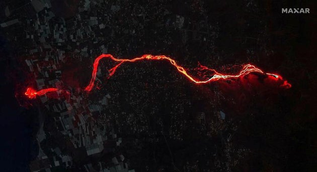 A composite image shows a satellite image of the lava flow from the Cumbre Vieja volcano on the Canary...