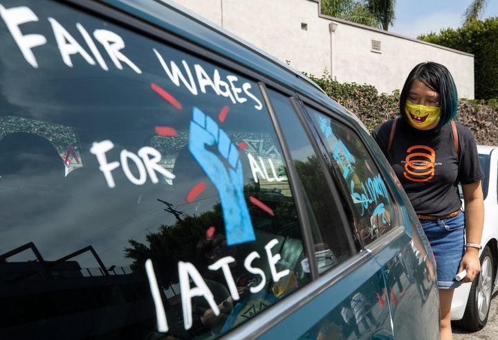 A strike by IATSE members would be the largest the U.S. private sector has seen since 2007. Here, a worker paints pro-union images on cars at a rally in Los Angeles in September.