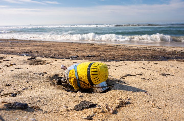 An oil soaked toy Minion washed up on shore at Huntington State Beach along with oil from a 126,000-gallon spill in Huntington Beach on Sunday, October 3, 2021. (Photo by Leonard Ortiz/MediaNews Group/Orange County Register via Getty Images)