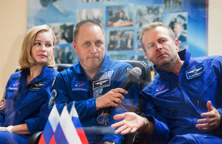 In this handout photo released by Roscosmos, actress Yulia Peresild, left, director Klim Shipenko, right, and cosmonaut Anton Shkaplerov, members of the prime crew of Soyuz MS-19 spaceship attend a news conference at the Russian launch facility in the Baikonur Cosmodrome, Kazakhstan on Oct. 4. 