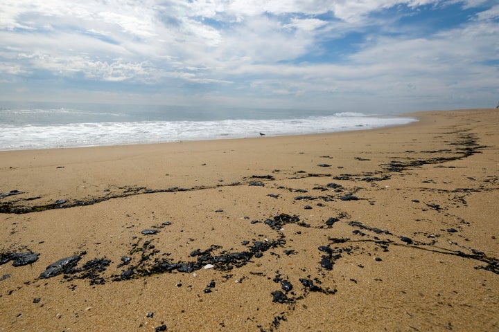 Oil streaks Newport Beach on Monday.