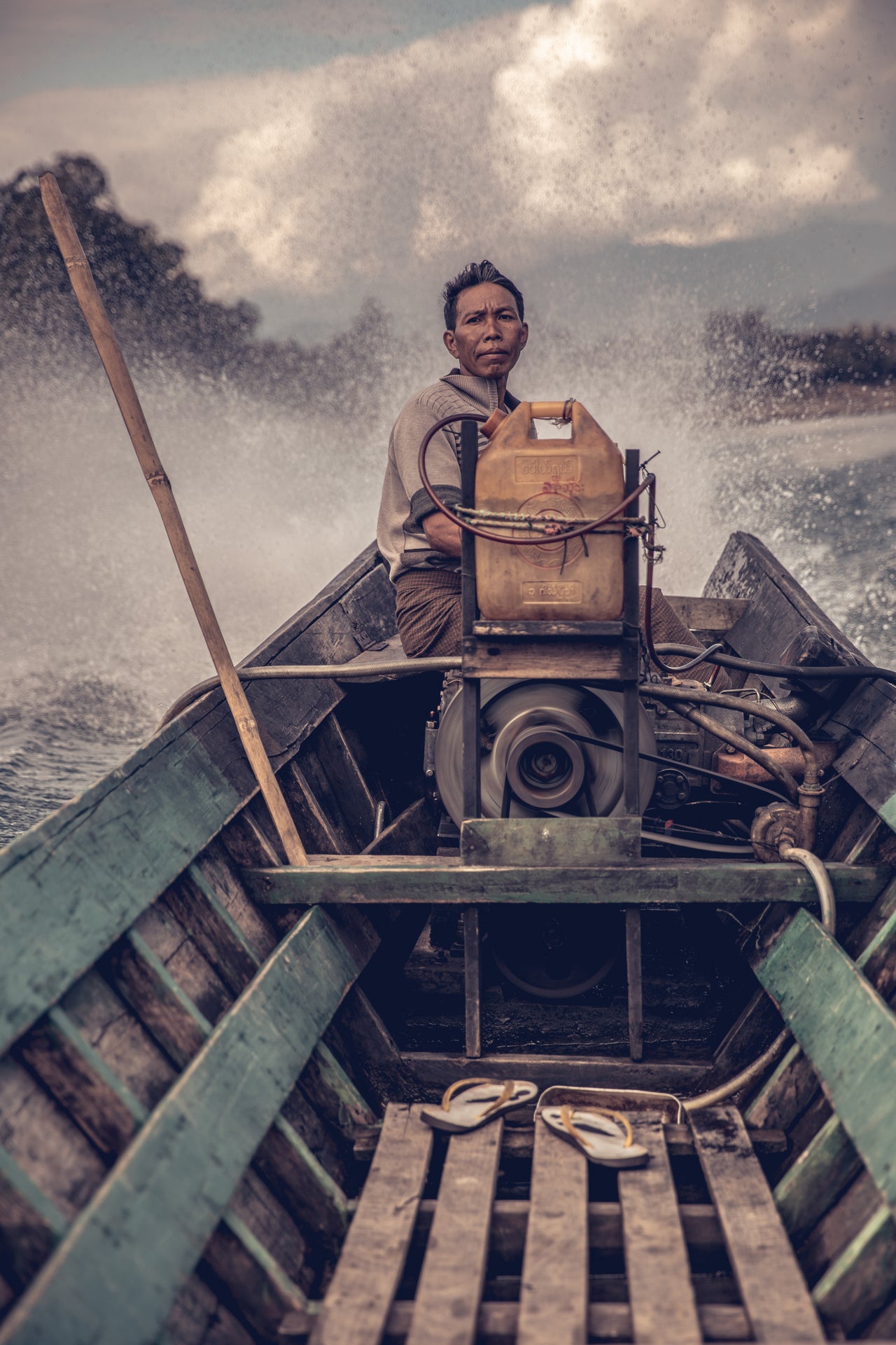 A local boatman in remote northern Myanmar, tackling a challenging water channel filled with rocks and rapids, by Rajiv Joshi