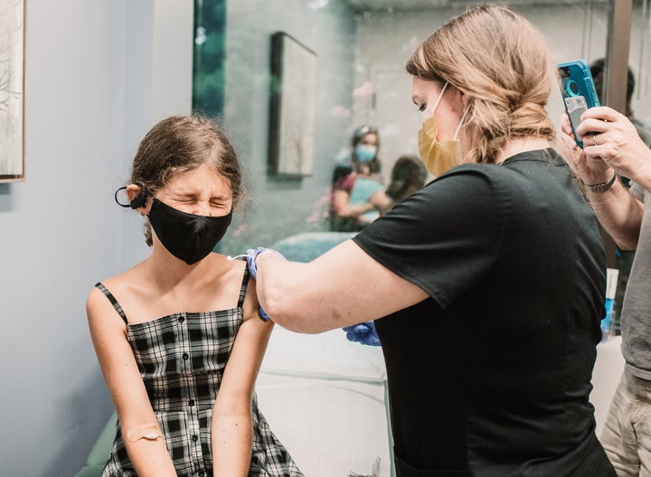 The author's 10-year-old daughter receives her first COVID-19 vaccine dose.