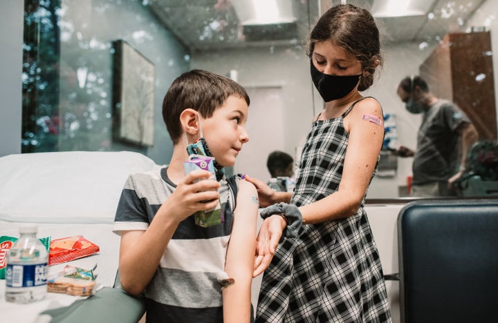 The author's children, ages 6 and 10, after they received their first COVID-19 vaccine dose.