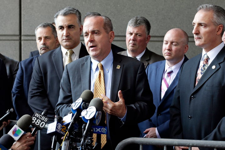 Sgt. Ed Mullins, the head of the Sergeants Benevolent Association, center, speaks to the media in 2017.