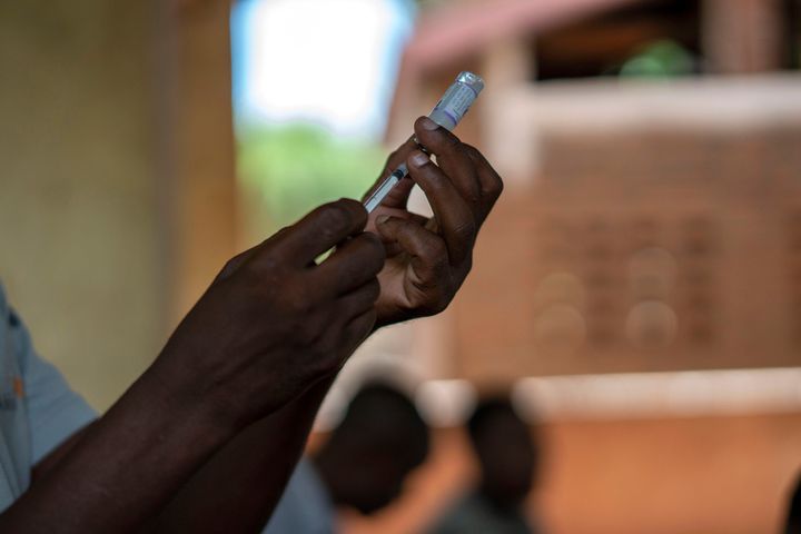 In this file photo taken Wednesday, Dec. 11, 2019, health officials prepare to vaccine residents of the Malawi village of Tomali, where young children become test subjects for the world's first vaccine against malaria. The World Health Organization recommended that the world’s first malaria vaccine be given to children across Africa, in a move officials hope will spur the stalled progress against efforts to curb the spread of the parasitic disease. (AP Photo/Jerome Delay, File)