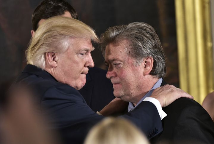 President Donald Trump congratulates Stephen Bannon during the swearing-in of senior staff in the East Room of the White House, Jan. 22, 2017.