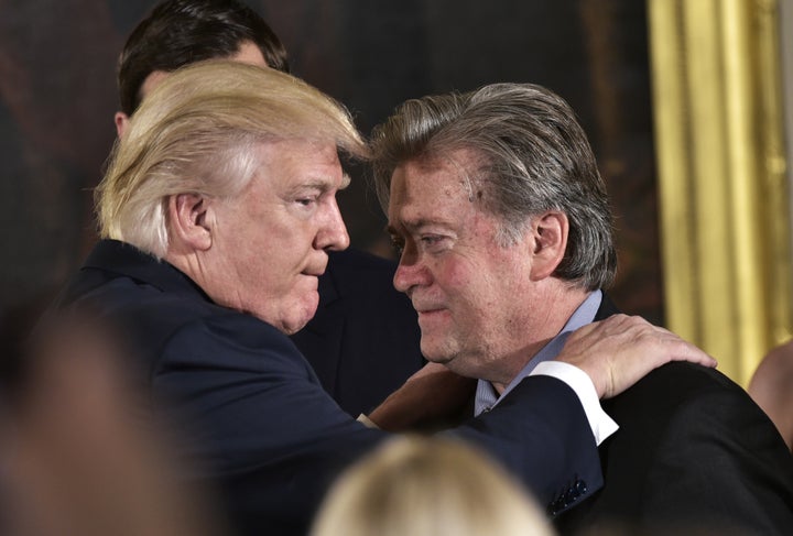 President Donald Trump congratulates Stephen Bannon during the swearing-in of senior staff in the East Room of the White House, Jan. 22, 2017.