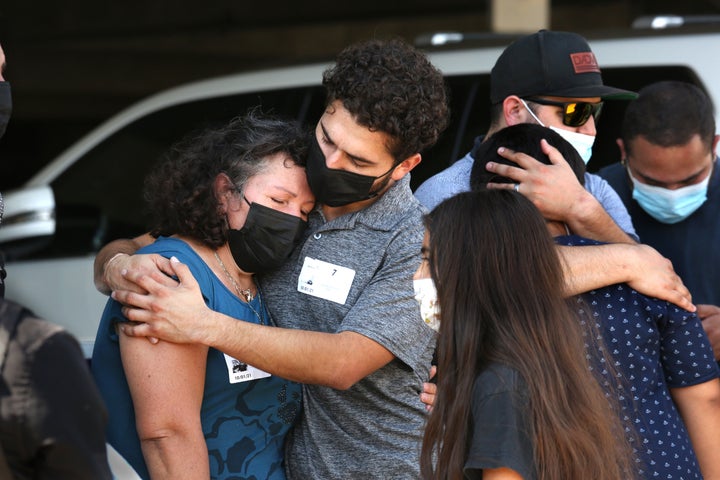 Mona Rodriguez's brother hugs her mother after a press conference on Oct. 1, 2021.