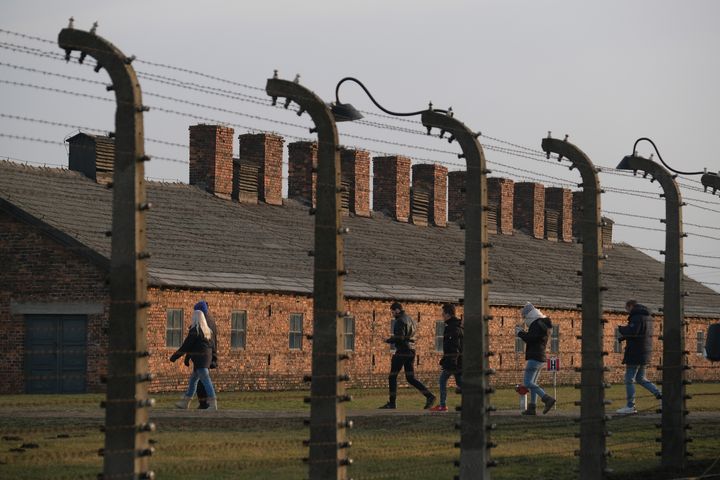 Barbed wire and prisoner barracks at the former Auschwitz-Birkenau German concentration camp