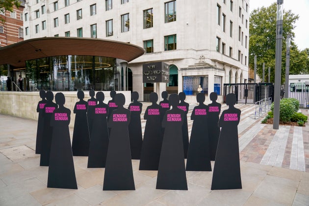 Silhouettes of women are placed outside New Scotland Yard by the British charity