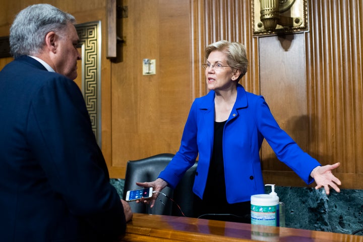 Rettig greets Sen. Elizabeth Warren (D-Mass.) before testifying during a June 8 Senate hearing on the IRS's 2022 budget request.