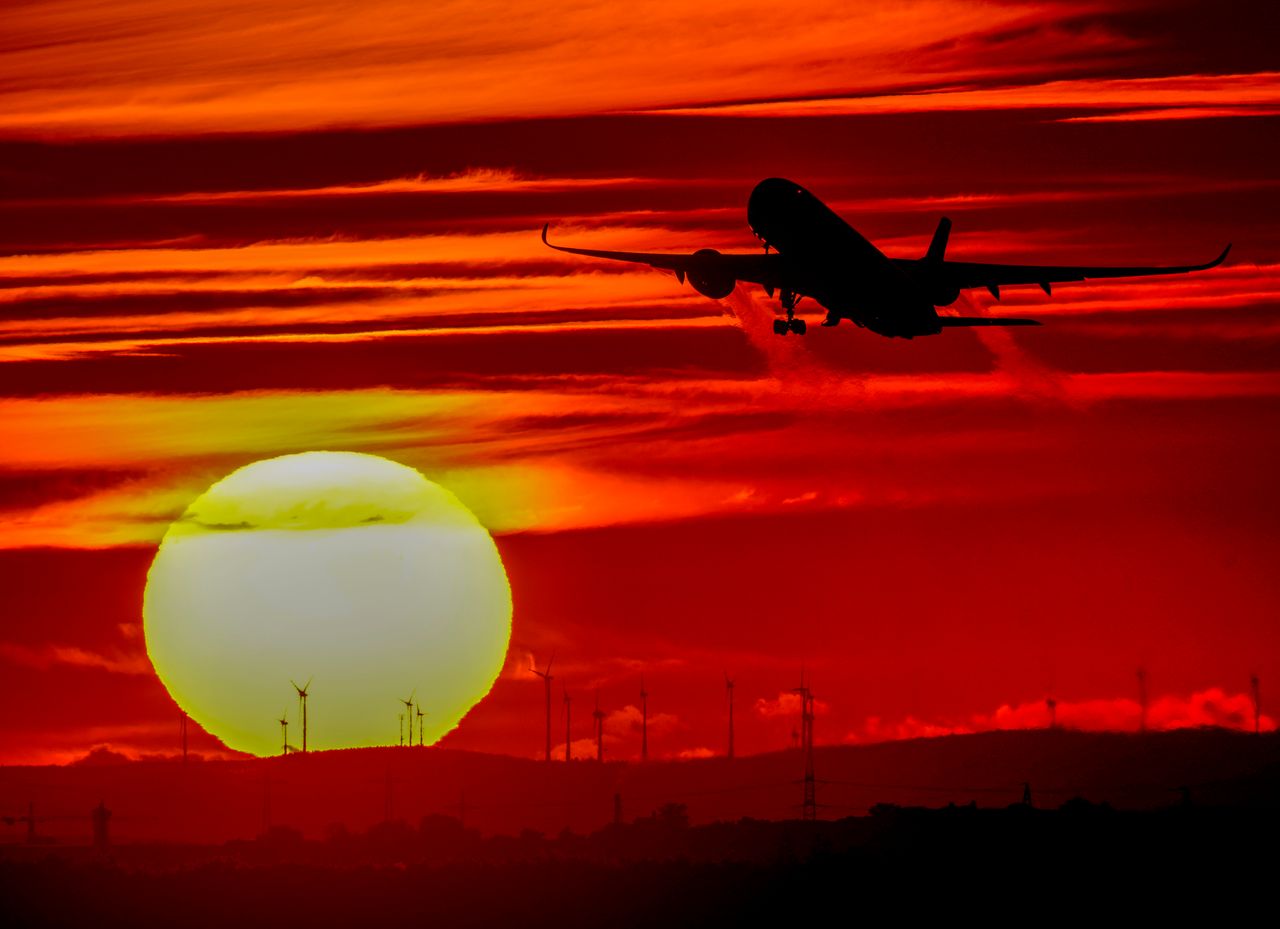 An aircraft takes off at the international airport as the sun sets in Frankfurt, Germany, on Oct. 4. 