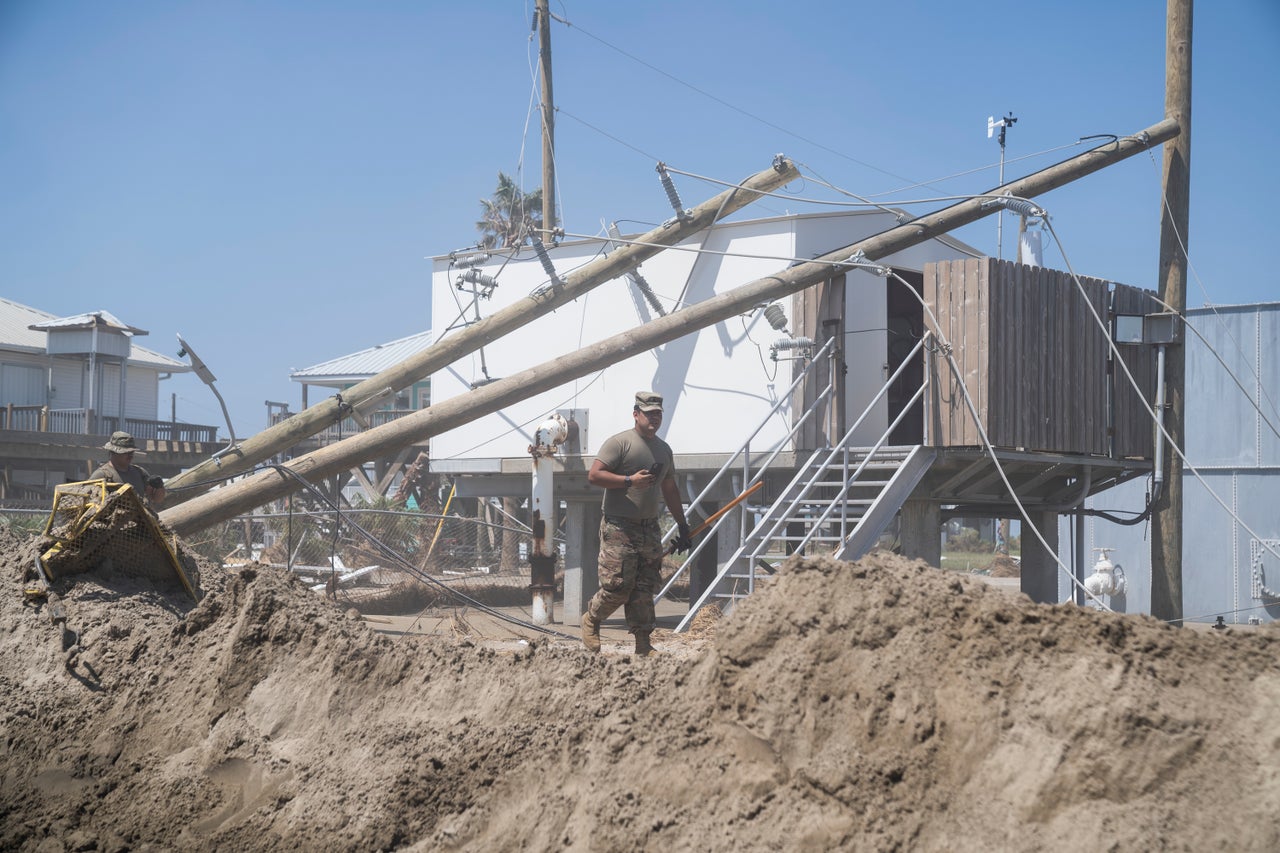 Members of the U.S. military assisting in the rebuilding effort on Grand Isle.