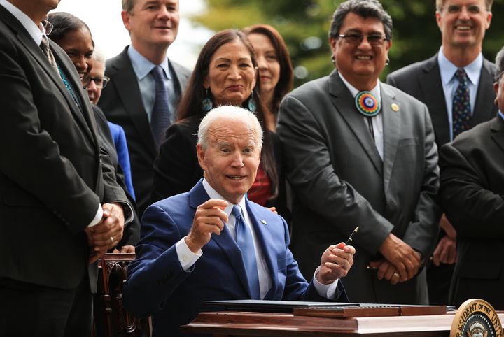 President Joe Biden finishes signing an executive order to expand the areas of three national monuments during an event at the White House on Friday. The Biden administration restored the areas of two Utah sites held sacred by several Native American tribes, Bears Ears National Monument and Grand Staircase-Escalante, as well as the Northeast Canyons and Seamounts monument off the New England coast, after former President Donald Trump opened them to mining, drilling and development during his time in office.