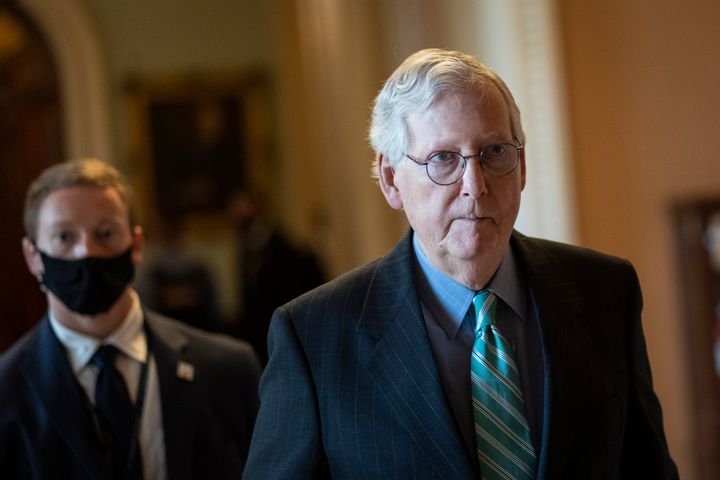 Senate Minority Leader Mitch McConnell (R-Ky.) returns to his office after a meeting with Senate Republicans on Thursday as they neared a deal to temporarily raise the debt ceiling.