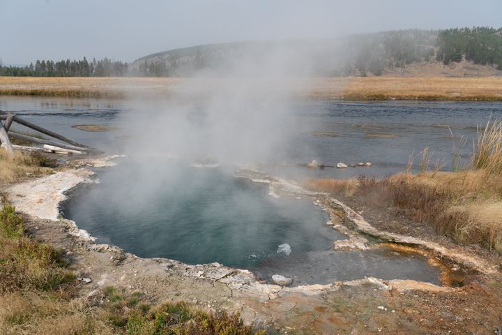Maiden's Grave Spring, where water temperatures are about 200 degrees Fahrenheit, by the Firehole RIver on the Fountain Flats Drive in Yellowstone National Park in Wyoming.