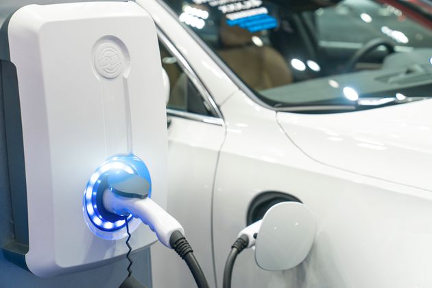 Charging modern electric car on the street which are the future of the