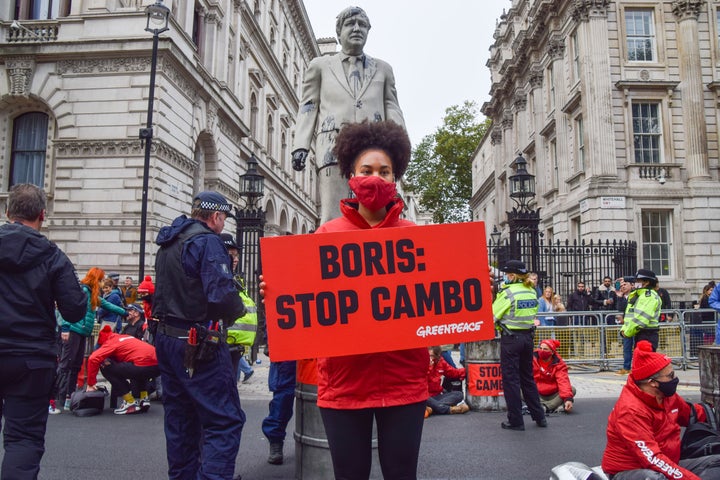 An activist holds a placard during a Stop Cambo protest by Greenpeace.